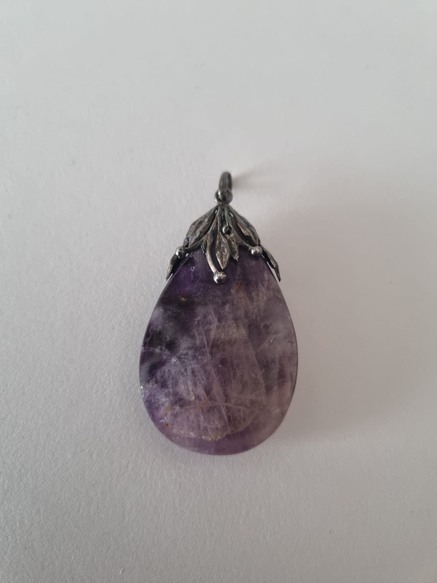 Antique Vintage Arts & Crafts style purple amethyst gemstone pendant with decorative sterling silver leaves.